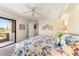 Bedroom featuring a floral comforter, access to a balcony, and neutral walls at 7220 E Mary Sharon Dr # 116, Scottsdale, AZ 85266