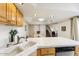 Open kitchen with tiled countertops, stainless steel dishwasher, and staircase access at 7220 E Mary Sharon Dr # 116, Scottsdale, AZ 85266