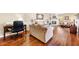 Spacious living room featuring hardwood floors, comfortable sofas, and a workspace at 7220 E Mary Sharon Dr # 116, Scottsdale, AZ 85266