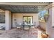 Covered patio with tile flooring, an outdoor dining table, and potted plants at 7220 E Mary Sharon Dr # 116, Scottsdale, AZ 85266