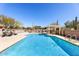 Sparkling pool with lounge chairs and desert landscaping at 7220 E Mary Sharon Dr # 116, Scottsdale, AZ 85266