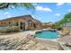 Beautiful backyard oasis with a private pool, patio area and lush landscaping at 7544 E Sierra Morena Cir, Mesa, AZ 85207