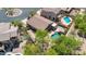 Backyard featuring a sparkling pool surrounded by mature trees, offering a private and serene escape at 7544 E Sierra Morena Cir, Mesa, AZ 85207