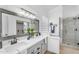 Elegant bathroom with double sinks, large framed mirror, and walk-in shower at 7544 E Sierra Morena Cir, Mesa, AZ 85207