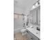 Bright bathroom featuring a shower and tub combo, toilet, and vanity with a framed mirror at 7544 E Sierra Morena Cir, Mesa, AZ 85207