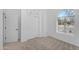 Bright bedroom featuring a large window, carpeted floor and built in closet and cabinets at 7544 E Sierra Morena Cir, Mesa, AZ 85207
