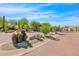 Inviting community entrance with lush desert landscaping and stone accents at 7544 E Sierra Morena Cir, Mesa, AZ 85207
