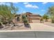 Inviting single-story home displays a stone facade, desert landscaping, and a two car garage at 7544 E Sierra Morena Cir, Mesa, AZ 85207