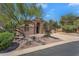 Charming single-story home features a stone facade, desert landscaping, and arched entryway at 7544 E Sierra Morena Cir, Mesa, AZ 85207