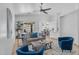 Cozy living room featuring bright furniture, a fan, and a sliding door to outside pool area at 7544 E Sierra Morena Cir, Mesa, AZ 85207