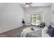 Bright bedroom with ceiling fan, patio access, and a serene pool view at 7544 E Sierra Morena Cir, Mesa, AZ 85207