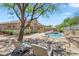 Inviting backyard showcasing a pristine pool, lounge chairs, and lush landscaping at 7544 E Sierra Morena Cir, Mesa, AZ 85207