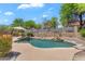 Stunning private pool with lush landscaping and a waterfall feature in a backyard setting at 7544 E Sierra Morena Cir, Mesa, AZ 85207