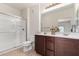 Bathroom with a double sink vanity, framed mirror, and a glass-enclosed shower at 7726 E Baseline Rd # 134, Mesa, AZ 85209