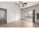 Bedroom features tile flooring, sliding glass door to balcony, and closet space at 7726 E Baseline Rd # 134, Mesa, AZ 85209