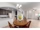 A dining area with an open view to the kitchen, light fixtures, and views of the living area at 7726 E Baseline Rd # 134, Mesa, AZ 85209