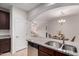 Bright kitchen with stainless steel appliances, granite countertops, and an open view to the living room at 7726 E Baseline Rd # 134, Mesa, AZ 85209