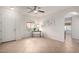 Open-concept living room with tile flooring and a ceiling fan, leading to an arched entry at 7726 E Baseline Rd # 134, Mesa, AZ 85209