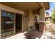 Relaxing outdoor patio featuring a sliding glass door, stone accents and stylish patio furniture at 7726 E Baseline Rd # 134, Mesa, AZ 85209