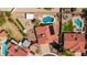Aerial view of a neighborhood showcasing a home with a red tile roof, backyard pool and outdoor entertaining areas at 7726 W Cameron Dr, Peoria, AZ 85345