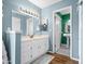 Well-lit bathroom featuring a vanity, sink, and additional space looking into another room at 7726 W Cameron Dr, Peoria, AZ 85345