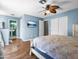 Spacious bedroom with a view into an attached bathroom featuring an open entryway and bright vanity sink at 7726 W Cameron Dr, Peoria, AZ 85345