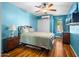 Comfortable bedroom featuring hardwood floors, natural lighting and a ceiling fan at 7726 W Cameron Dr, Peoria, AZ 85345