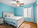 Comfortable bedroom featuring hardwood floors, natural lighting and a ceiling fan at 7726 W Cameron Dr, Peoria, AZ 85345