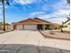 Charming single-story home featuring a three-car garage, desert landscaping, and a well-maintained yard at 7726 W Cameron Dr, Peoria, AZ 85345