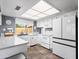 Bright eat-in kitchen featuring all-white appliances, cabinetry, and ample counter space for cooking and meal prep at 7726 W Cameron Dr, Peoria, AZ 85345
