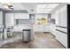 Bright eat-in kitchen featuring all-white appliances, cabinetry, and ample counter space for cooking and meal prep at 7726 W Cameron Dr, Peoria, AZ 85345