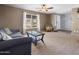 Spacious living room with plush carpet, a ceiling fan, and a window at 7726 W Cameron Dr, Peoria, AZ 85345