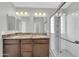 Bathroom featuring double sinks, granite countertops, and a glass-enclosed shower at 913 W Juanita Ave, Gilbert, AZ 85233
