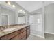 Bathroom featuring double sinks, granite countertops, and a glass-enclosed shower at 913 W Juanita Ave, Gilbert, AZ 85233