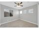 Bright bedroom featuring tile flooring, ceiling fan, and multiple windows at 913 W Juanita Ave, Gilbert, AZ 85233