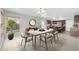 Open dining area featuring a marble-topped table, seating for six, and kitchen views at 913 W Juanita Ave, Gilbert, AZ 85233