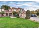 Charming two-story home featuring a well-manicured lawn, desert landscaping, and a welcoming double-door entrance at 913 W Juanita Ave, Gilbert, AZ 85233