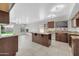 Well-lit kitchen showcasing granite countertops, tile floors, and a functional center island at 913 W Juanita Ave, Gilbert, AZ 85233