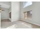 Bright living room offers neutral paint, tile floors, fan, and large windows for natural light at 913 W Juanita Ave, Gilbert, AZ 85233