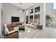 Bright living room with high ceilings, large windows, ceiling fan, neutral color palette and modern furniture at 913 W Juanita Ave, Gilbert, AZ 85233