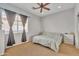 Bright bedroom with neutral walls, ceiling fan, carpet and ample natural light from the large window at 9626 W Bajada Rd, Peoria, AZ 85383