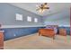 Spacious bedroom featuring a ceiling fan, carpet flooring and a large picture window at 9626 W Bajada Rd, Peoria, AZ 85383
