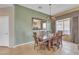 Formal dining room with chandelier, large mirror and ample natural light at 9626 W Bajada Rd, Peoria, AZ 85383