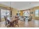 Formal dining room with chandelier and dining table with seating for eight, and connected living room at 9626 W Bajada Rd, Peoria, AZ 85383