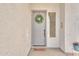 Inviting front entrance with wreath and 'home sweet home' door mat at 9626 W Bajada Rd, Peoria, AZ 85383