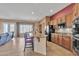 Open kitchen featuring a granite island with seating and stainless steel appliances at 9626 W Bajada Rd, Peoria, AZ 85383