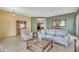Open-concept living room with tile flooring, modern decor, and a connected dining area at 9626 W Bajada Rd, Peoria, AZ 85383