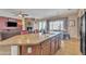 Open concept living room with kitchen island, dining area, and fireplace at 9626 W Bajada Rd, Peoria, AZ 85383