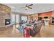 Spacious living room with a stone fireplace and open concept design at 9626 W Bajada Rd, Peoria, AZ 85383