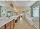 Spacious bathroom with dual sinks, vanity, bathtub, and glass enclosed shower room at 9626 W Bajada Rd, Peoria, AZ 85383